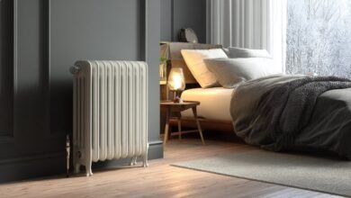 Обогреватель стоит у окна в тёплой комнате зимой